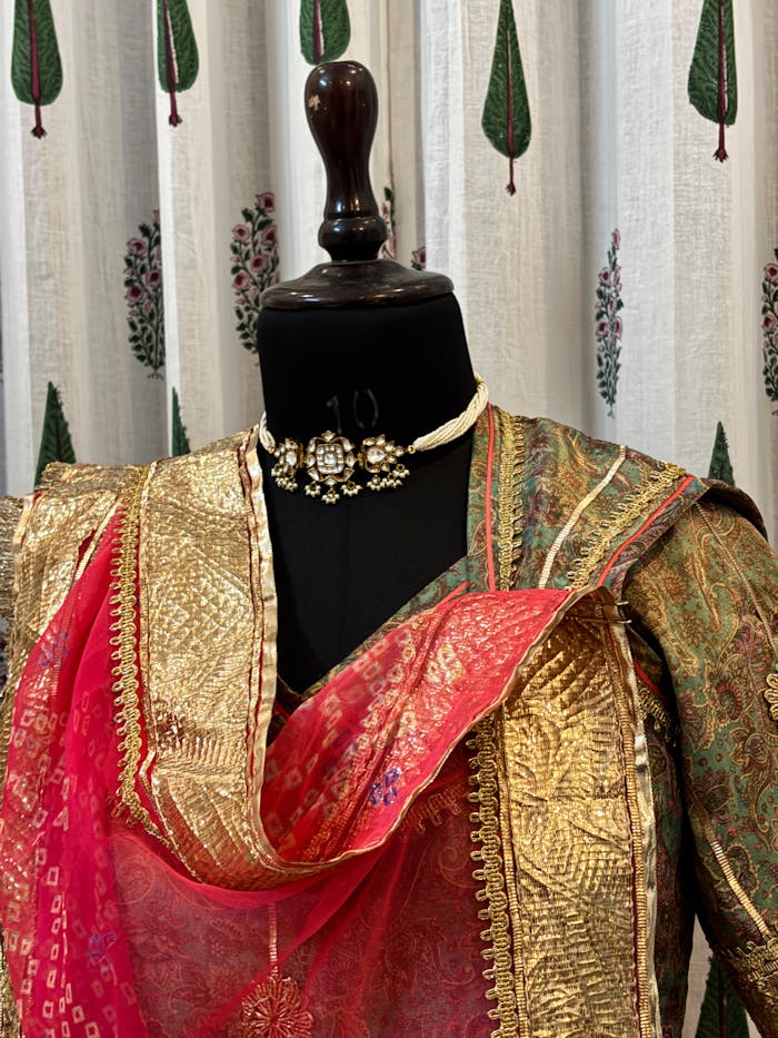 Vibrant Indian saree showcased on a mannequin with intricate embroidery design.
